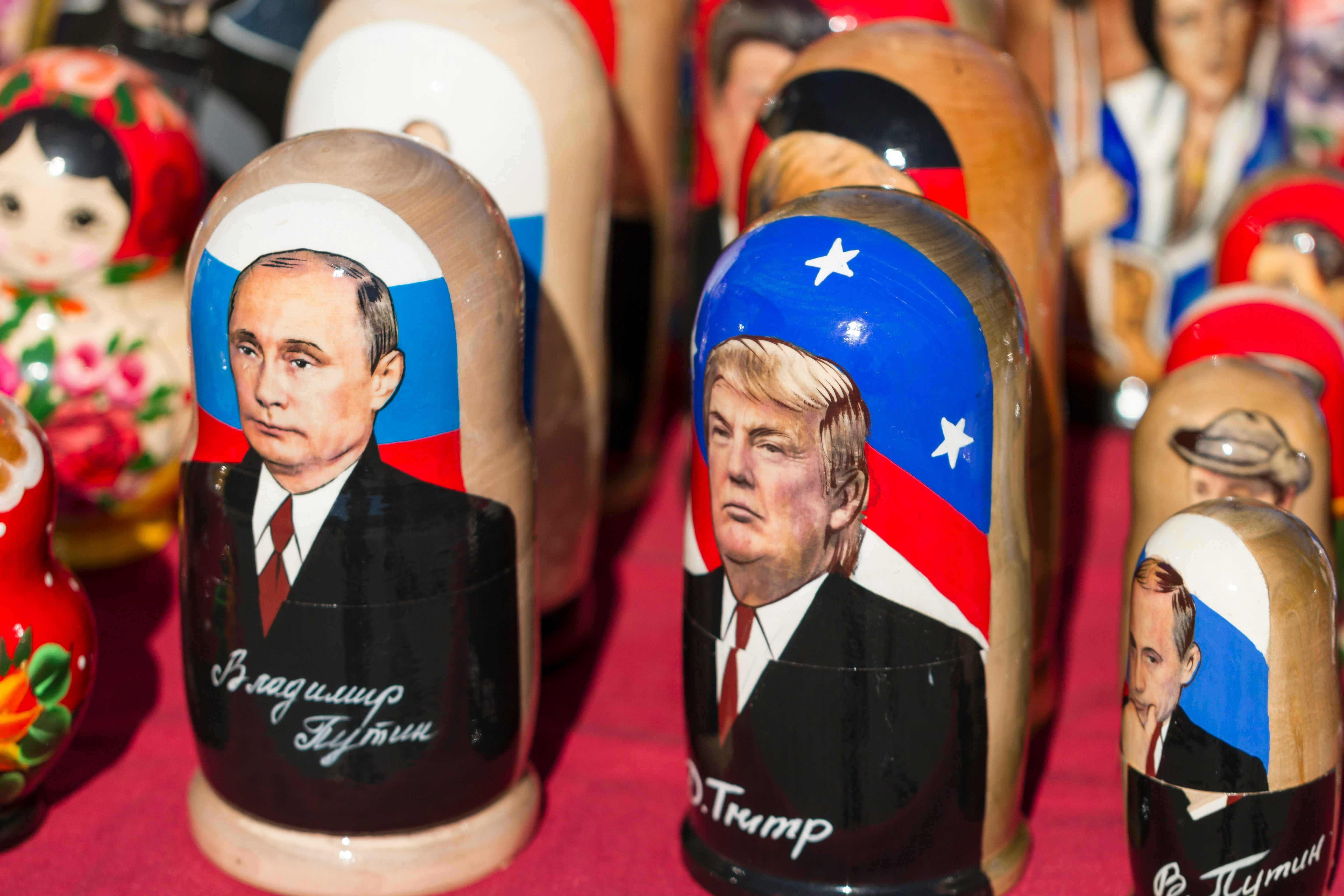 Donald Trump nesting dolls on red textile